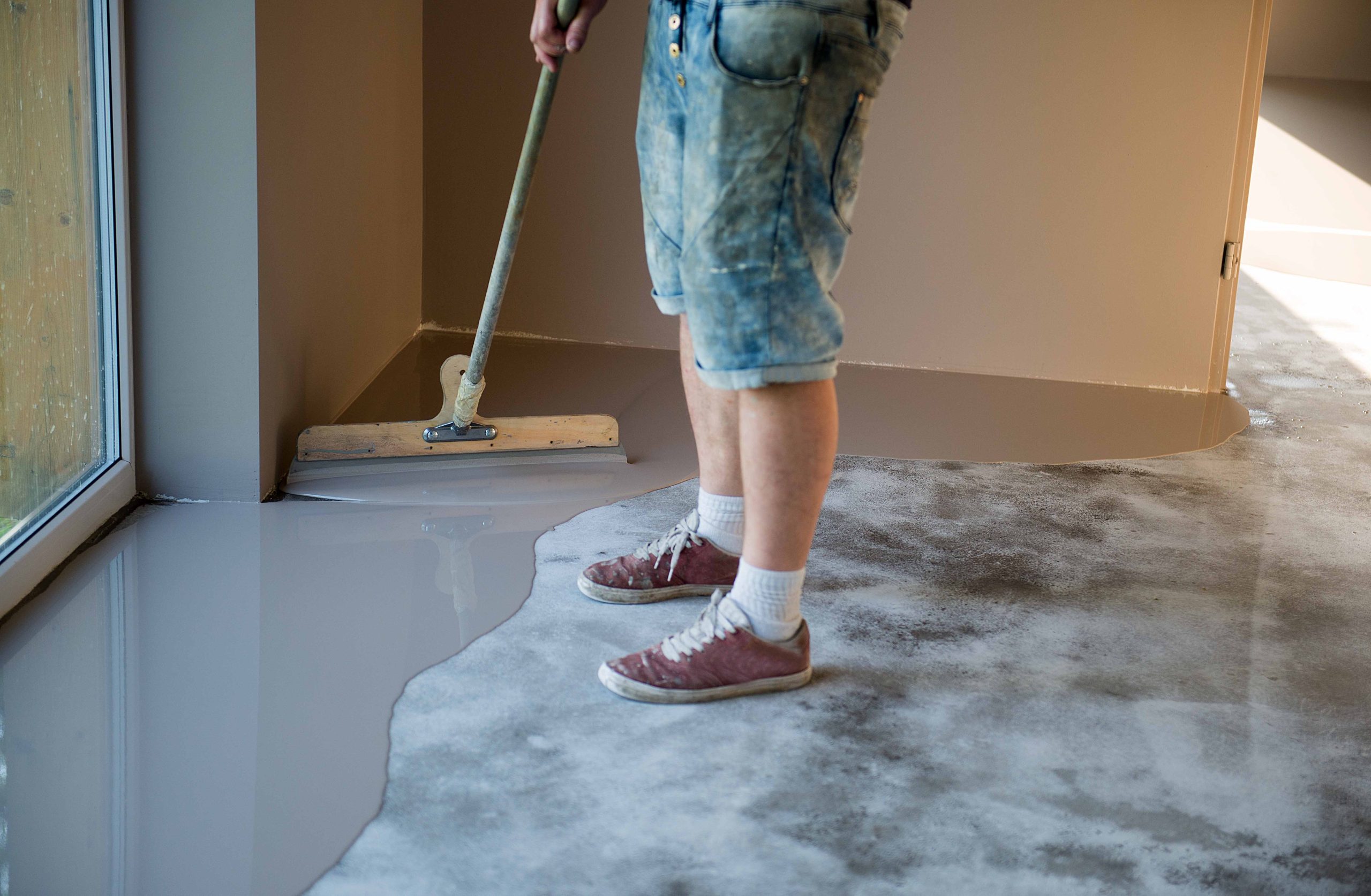 man-smoothing-concrete-floor-inside-a-residential-2026-03-20-01-00-02-utc
